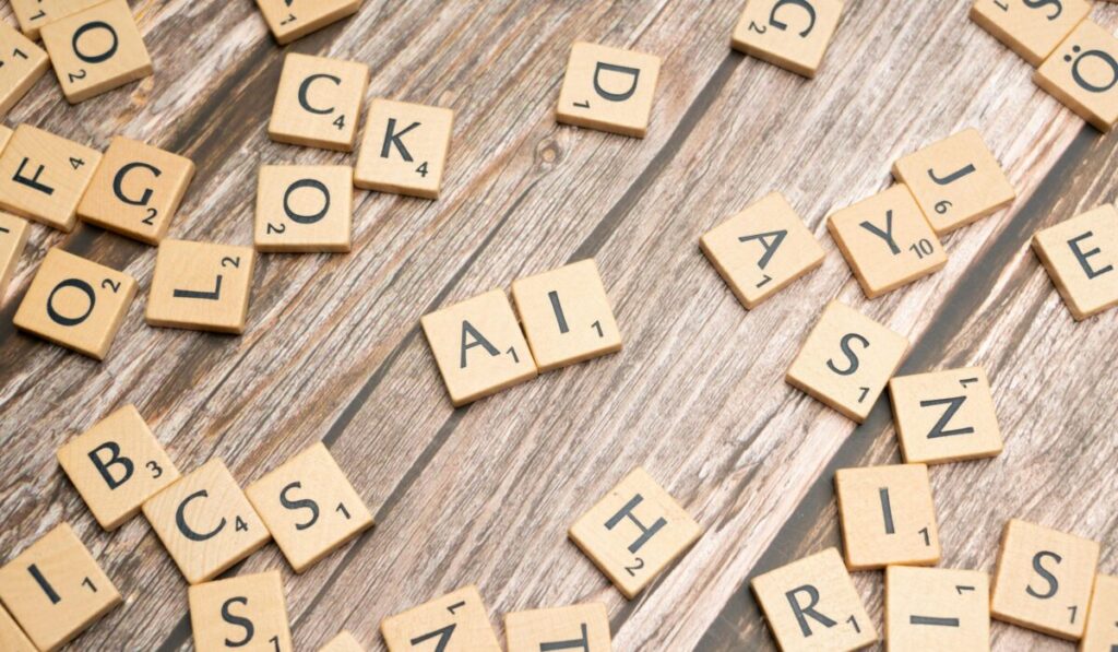 Wooden letter tiles scattered on a textured surface, spelling 'AI'. — Photo by Markus Winkler on Pexels