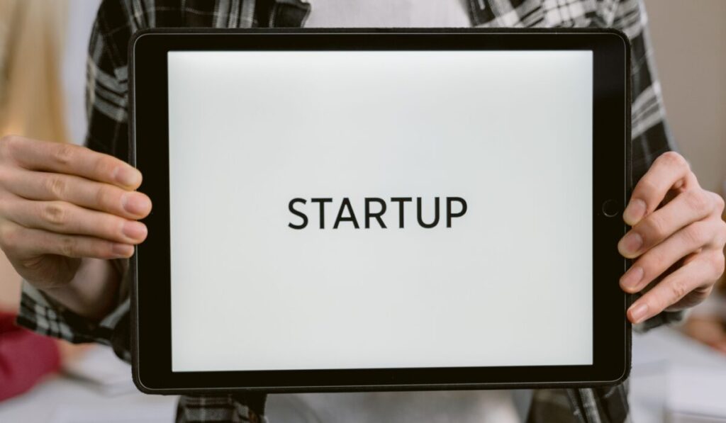 Person holding a digital tablet displaying the word 'STARTUP', representing new business concepts. — Photo by Tima Miroshnichenko on Pexels